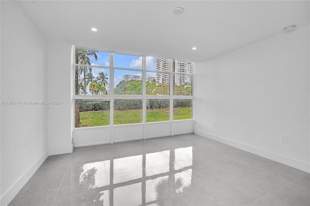 unfurnished room featuring light tile flooring