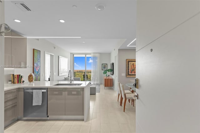 kitchen with kitchen peninsula, sink, and stainless steel dishwasher