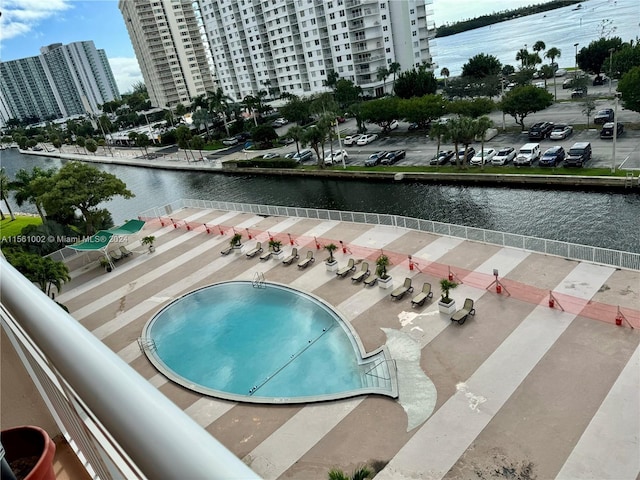 view of pool featuring a water view