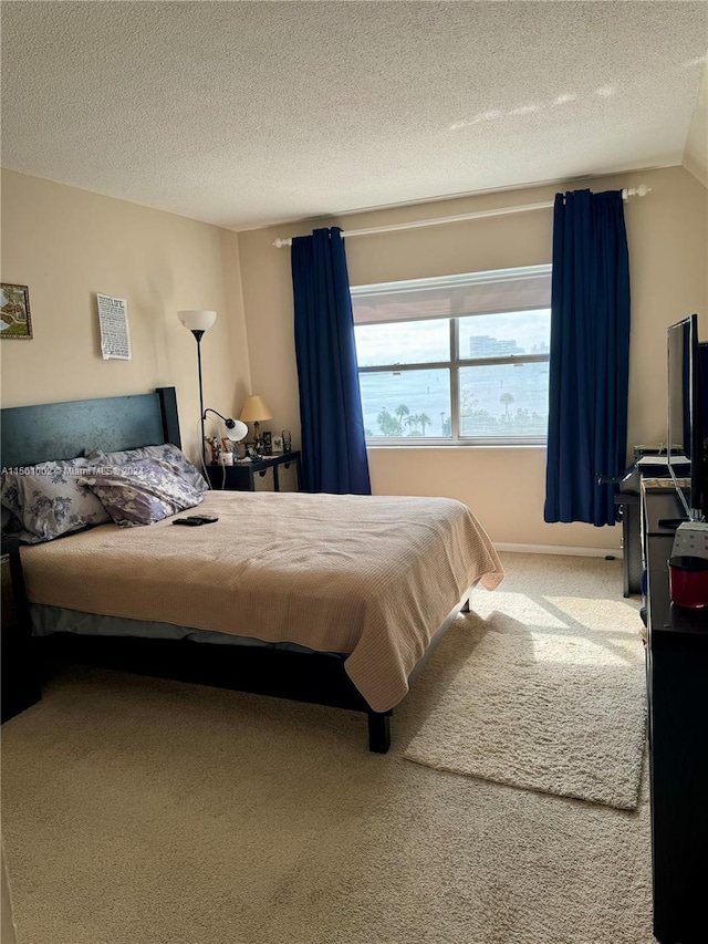 bedroom featuring lofted ceiling, light colored carpet, and a textured ceiling