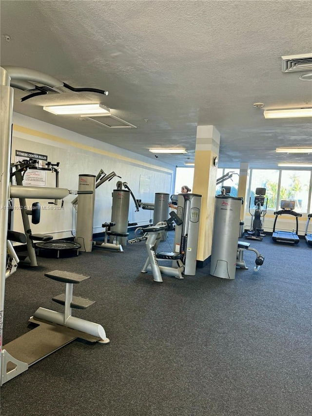 exercise room with a textured ceiling