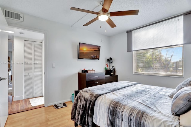 bedroom featuring a closet, ceiling fan, and light wood-type flooring