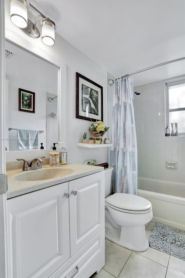 full bathroom with tile floors, toilet, vanity, and shower / tub combo with curtain