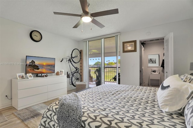 bedroom with ceiling fan, light hardwood / wood-style floors, access to outside, and a textured ceiling