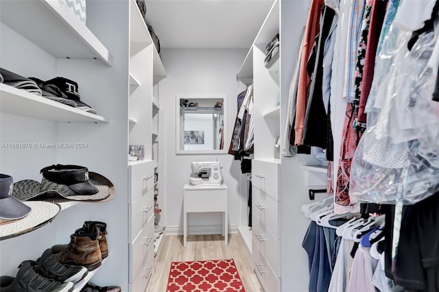 spacious closet with light hardwood / wood-style floors