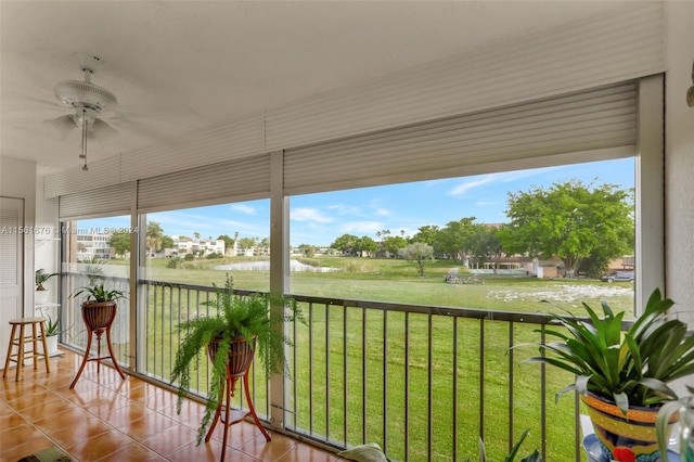 unfurnished sunroom featuring ceiling fan