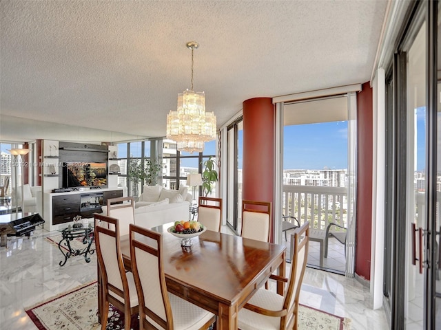 dining space with light tile floors, a notable chandelier, expansive windows, and a textured ceiling