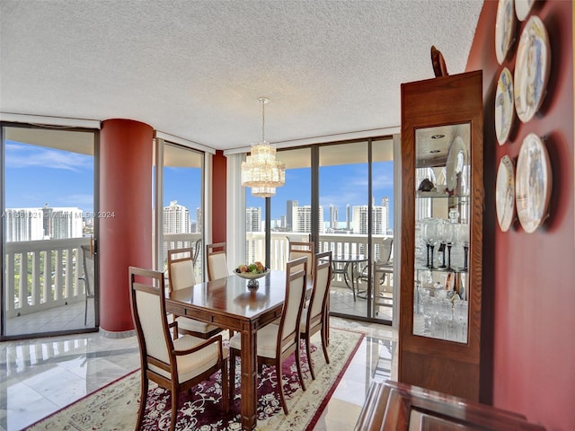 tiled dining area featuring a chandelier, a wall of windows, and a textured ceiling