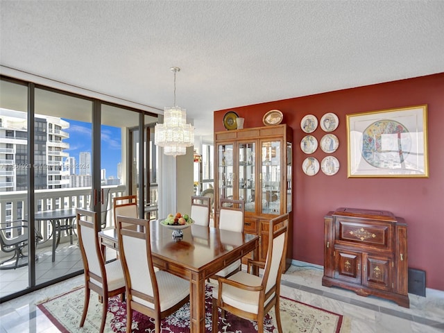 dining room with light tile flooring, a wall of windows, a textured ceiling, and an inviting chandelier