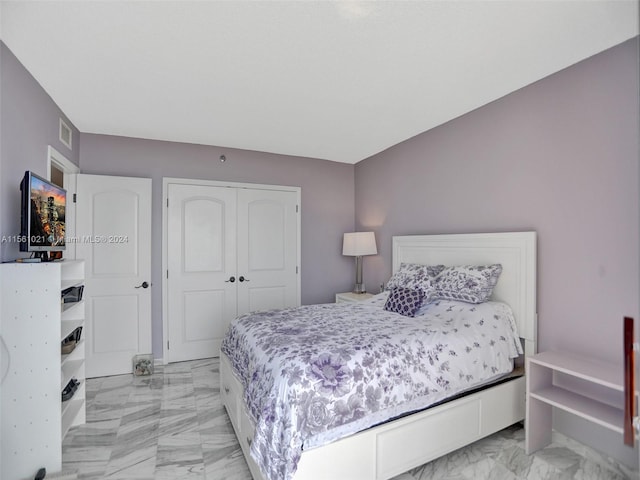 tiled bedroom with a closet