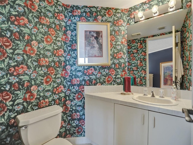 bathroom featuring toilet and vanity