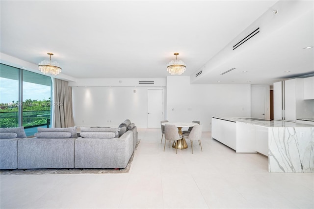 tiled living room with an inviting chandelier