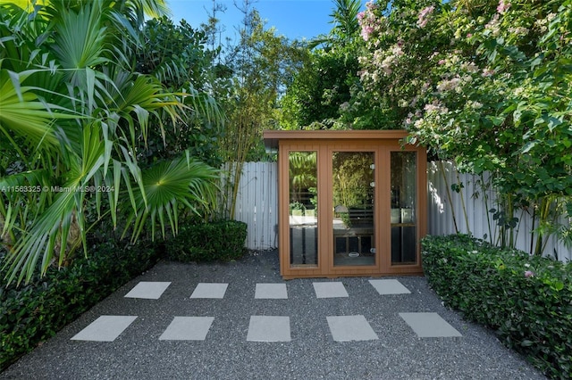 exterior space featuring fence and french doors