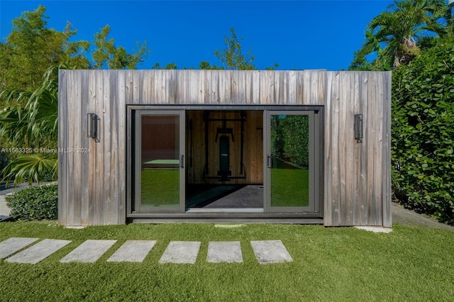 view of outbuilding featuring a lawn