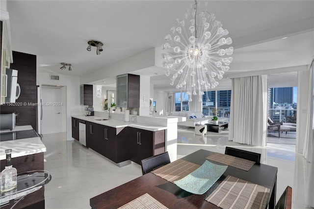 dining space with a chandelier and sink