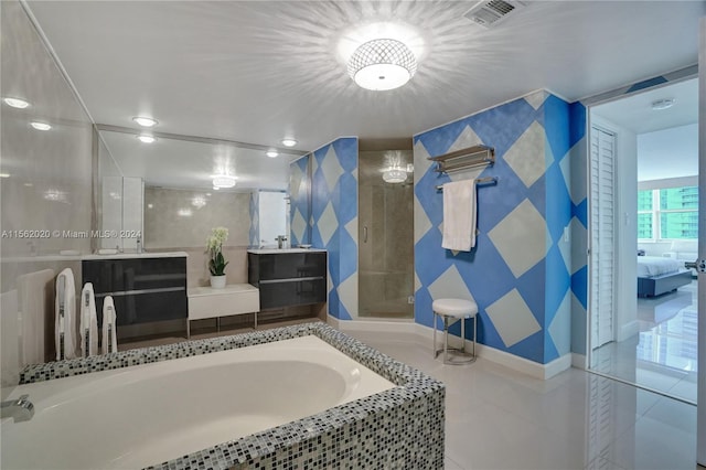 bathroom with shower with separate bathtub, tile patterned floors, and vanity