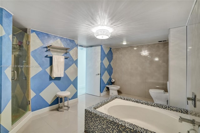 bathroom featuring independent shower and bath, tile walls, toilet, and tile patterned floors