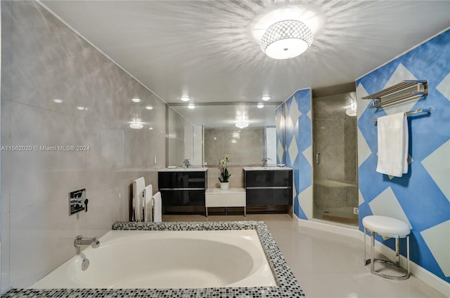 bathroom featuring independent shower and bath, vanity, and tile patterned floors