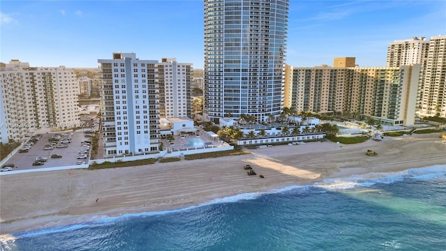 exterior space with a water view and a beach view