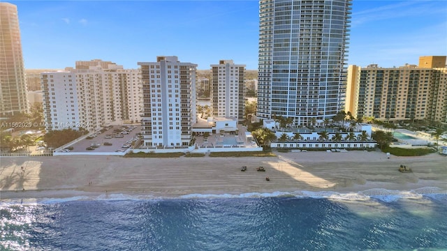 exterior space featuring a water view and a beach view