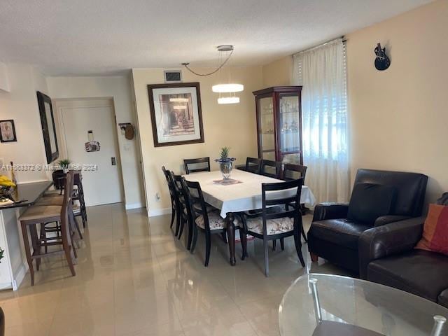 tiled dining area with an inviting chandelier