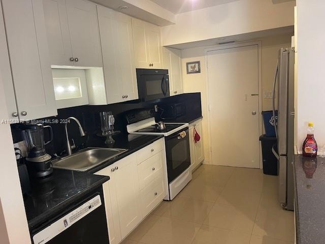 kitchen with white cabinetry, black appliances, sink, light tile floors, and tasteful backsplash