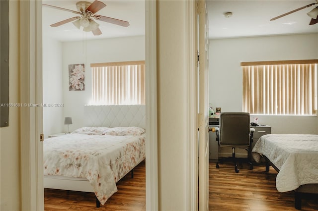 bedroom with ceiling fan and dark hardwood / wood-style floors