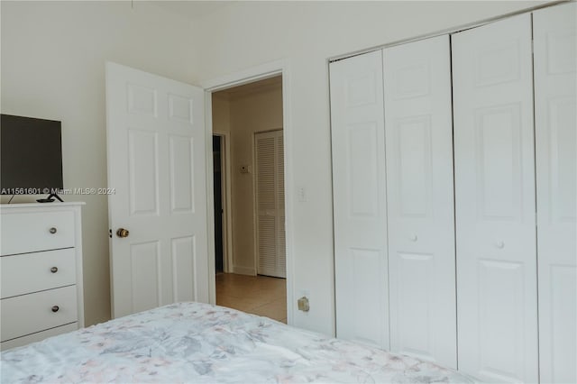 unfurnished bedroom featuring light tile floors