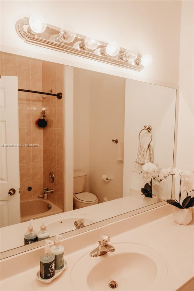 full bathroom featuring sink, toilet, and tiled shower / bath combo