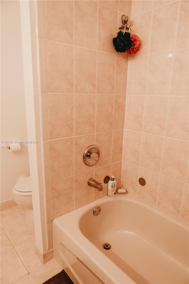 bathroom featuring tile flooring and toilet