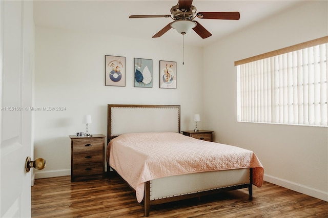 bedroom with ceiling fan and dark wood-type flooring