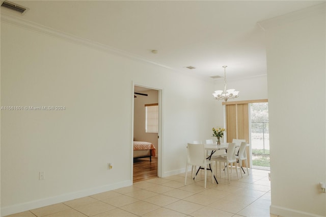 dining room with ornamental molding, light tile flooring, and ceiling fan with notable chandelier