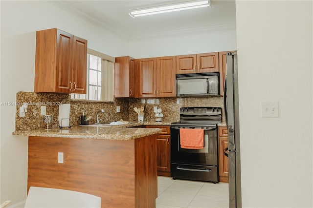 kitchen featuring light tile floors, kitchen peninsula, black appliances, light stone countertops, and sink