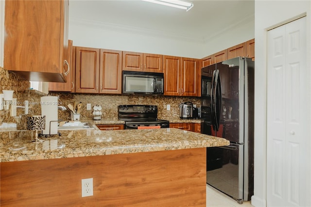 kitchen with light tile flooring, light stone countertops, kitchen peninsula, black appliances, and sink