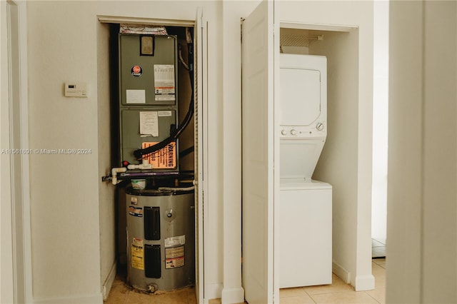 utility room featuring stacked washing maching and dryer and heating utilities