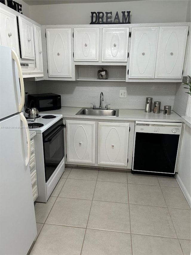 kitchen featuring white cabinetry, sink, light tile flooring, and black appliances