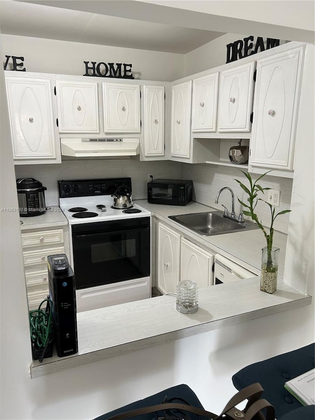 kitchen featuring white appliances, white cabinets, and sink