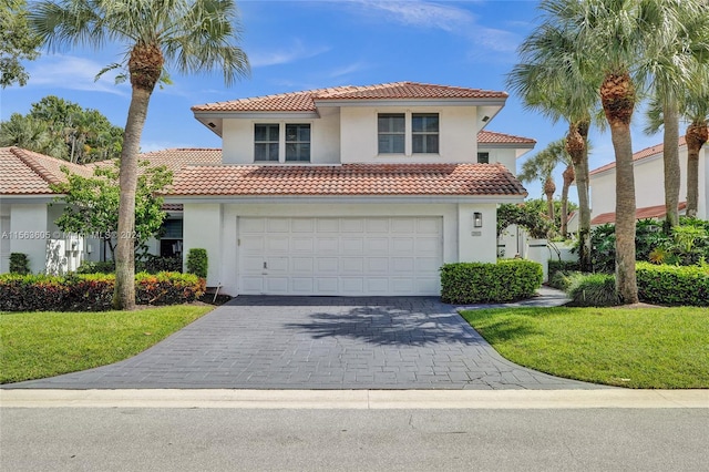 mediterranean / spanish-style home with a garage and a front yard