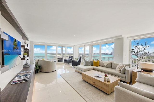 tiled living room featuring expansive windows and a water view