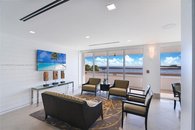 tiled living room with a water view