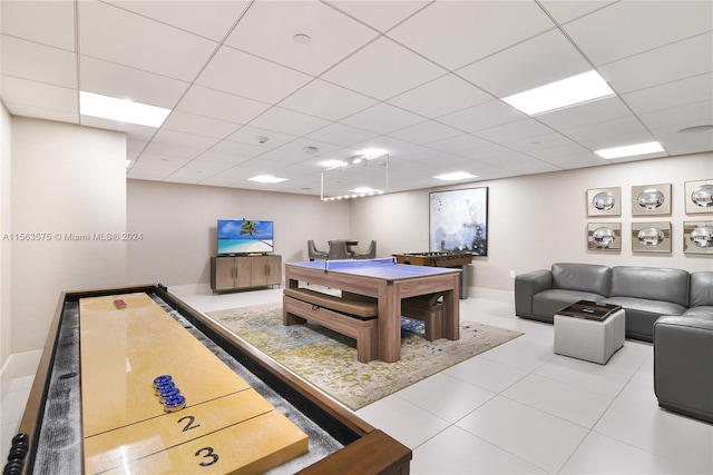 rec room featuring light tile floors and a drop ceiling