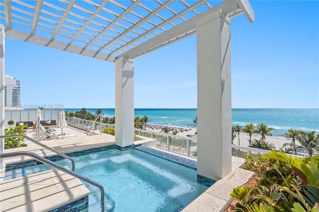 view of pool featuring a water view, a patio area, and a pergola