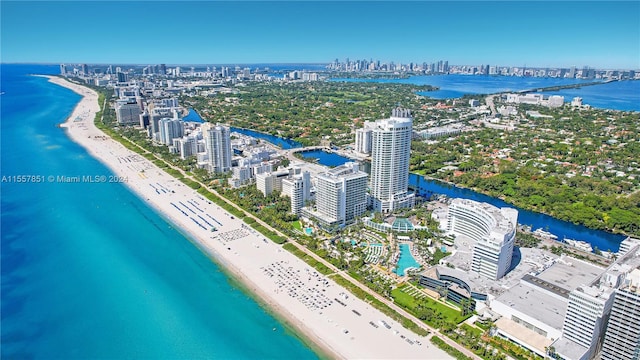 bird's eye view featuring a water view and a beach view