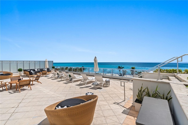 view of patio with a water view and a balcony