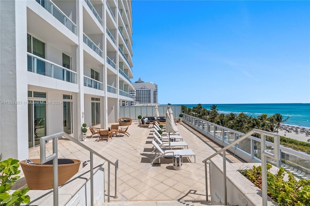 view of terrace featuring a balcony and a water view