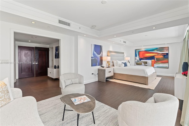 bedroom featuring a raised ceiling and dark hardwood / wood-style flooring