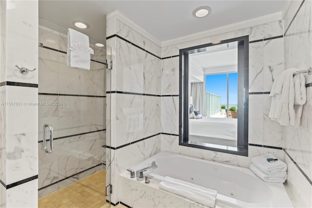 bathroom featuring separate shower and tub and tile walls