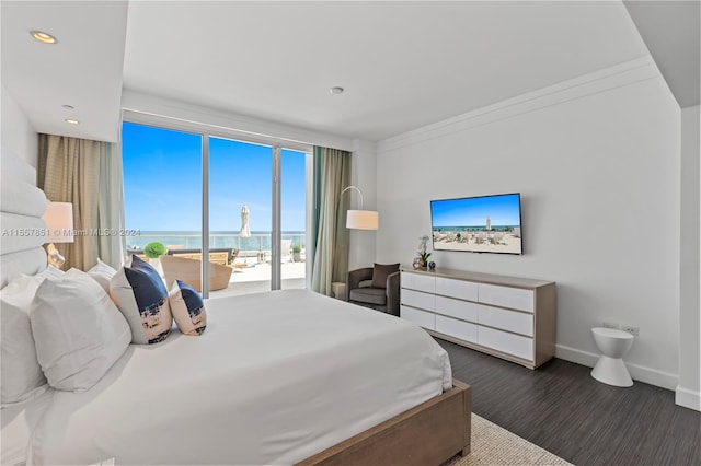 bedroom with ornamental molding, dark hardwood / wood-style floors, access to outside, and a water view