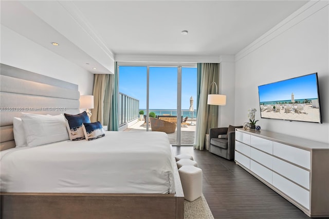 bedroom featuring a water view, dark hardwood / wood-style floors, crown molding, and access to exterior