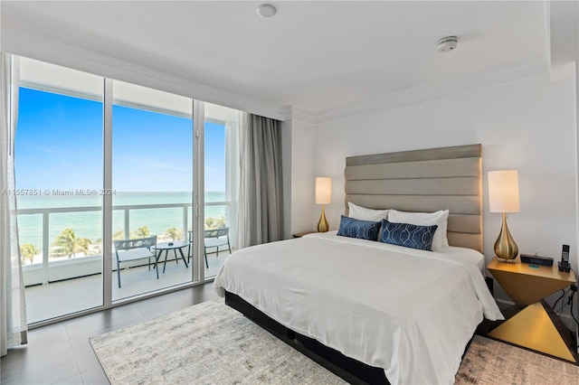 tiled bedroom with ornamental molding, access to outside, and a water view